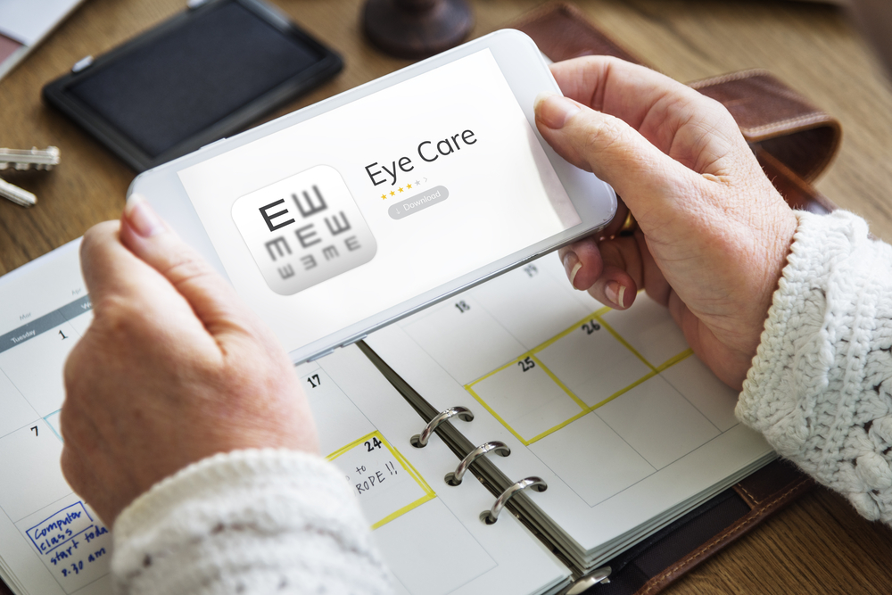 Hands,Working,On,Digital,Device,Network,Graphic,Overlay eye care in Tulsa