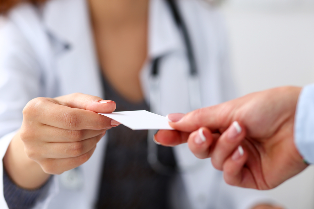 Female,Physician,Hand,Give,White,Blank,Calling,Card,To,Businesswoman insurance id card