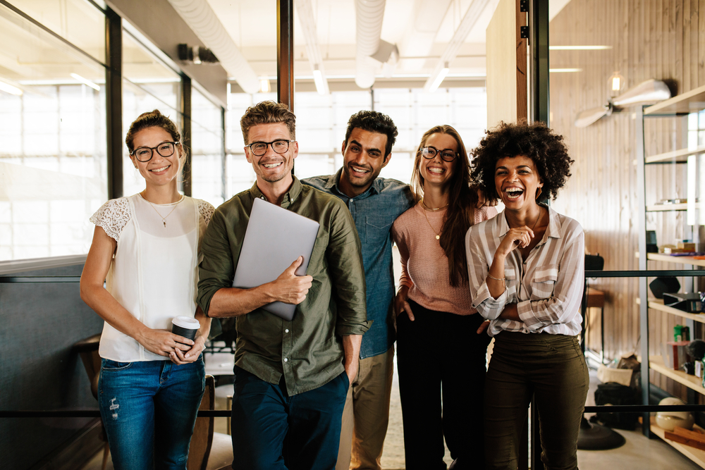 Portrait,Of,Creative,Business,Team,Standing,Together,And,Laughing.,Multiracial eye care in okc