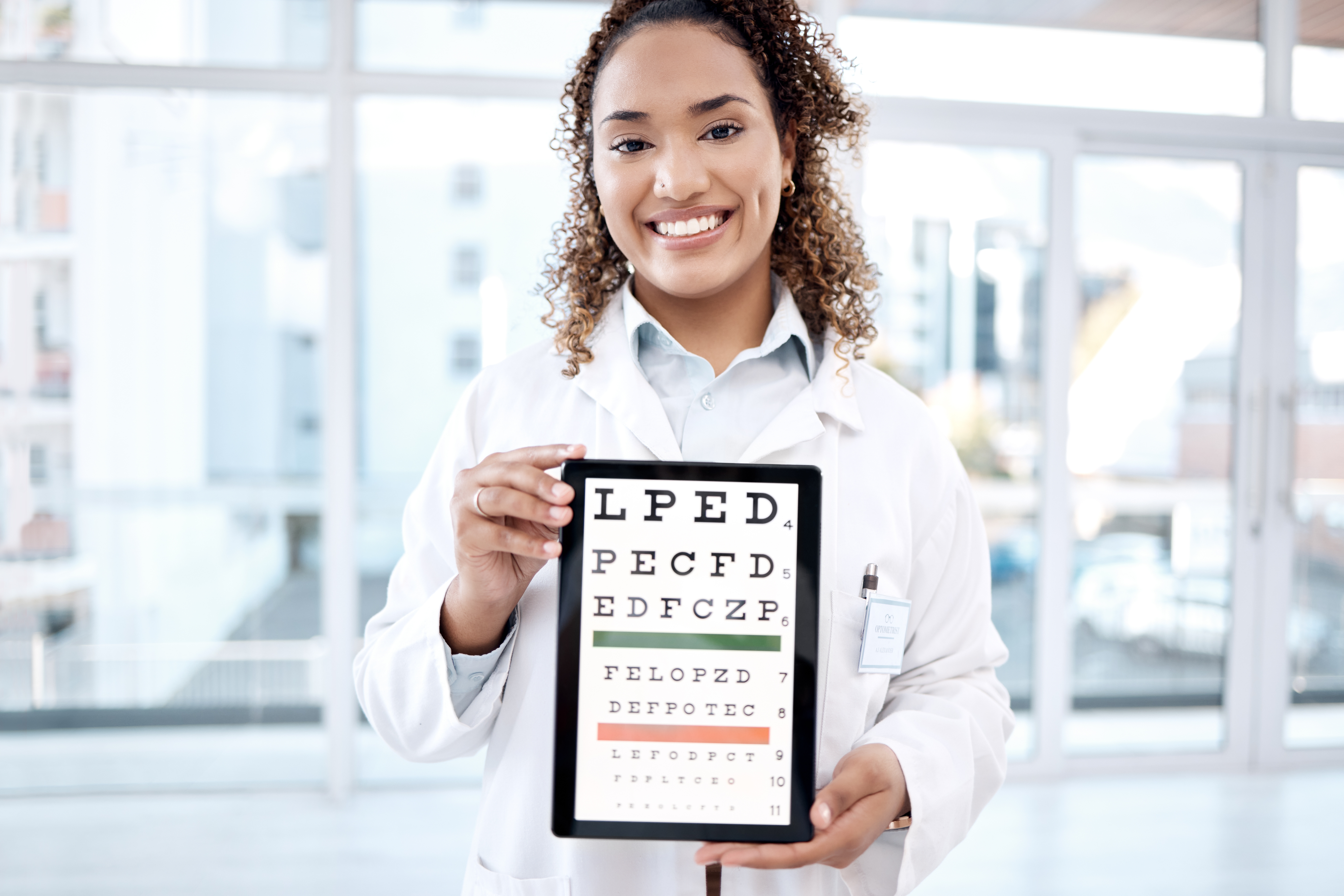 Portrait,,Eye,Chart,And,Doctor,With,Tablet,In,Hospital,For a doctor holding eye chart