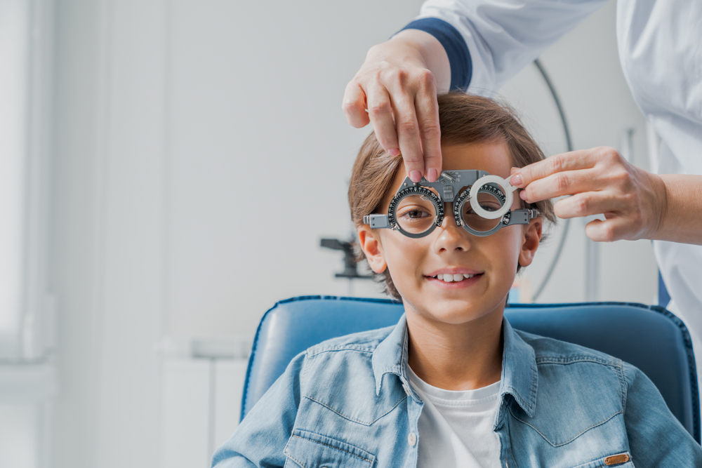 Smiling,Child,Boy,In,Glasses,Checks,Eye,Vision. what age can kids wear contacts