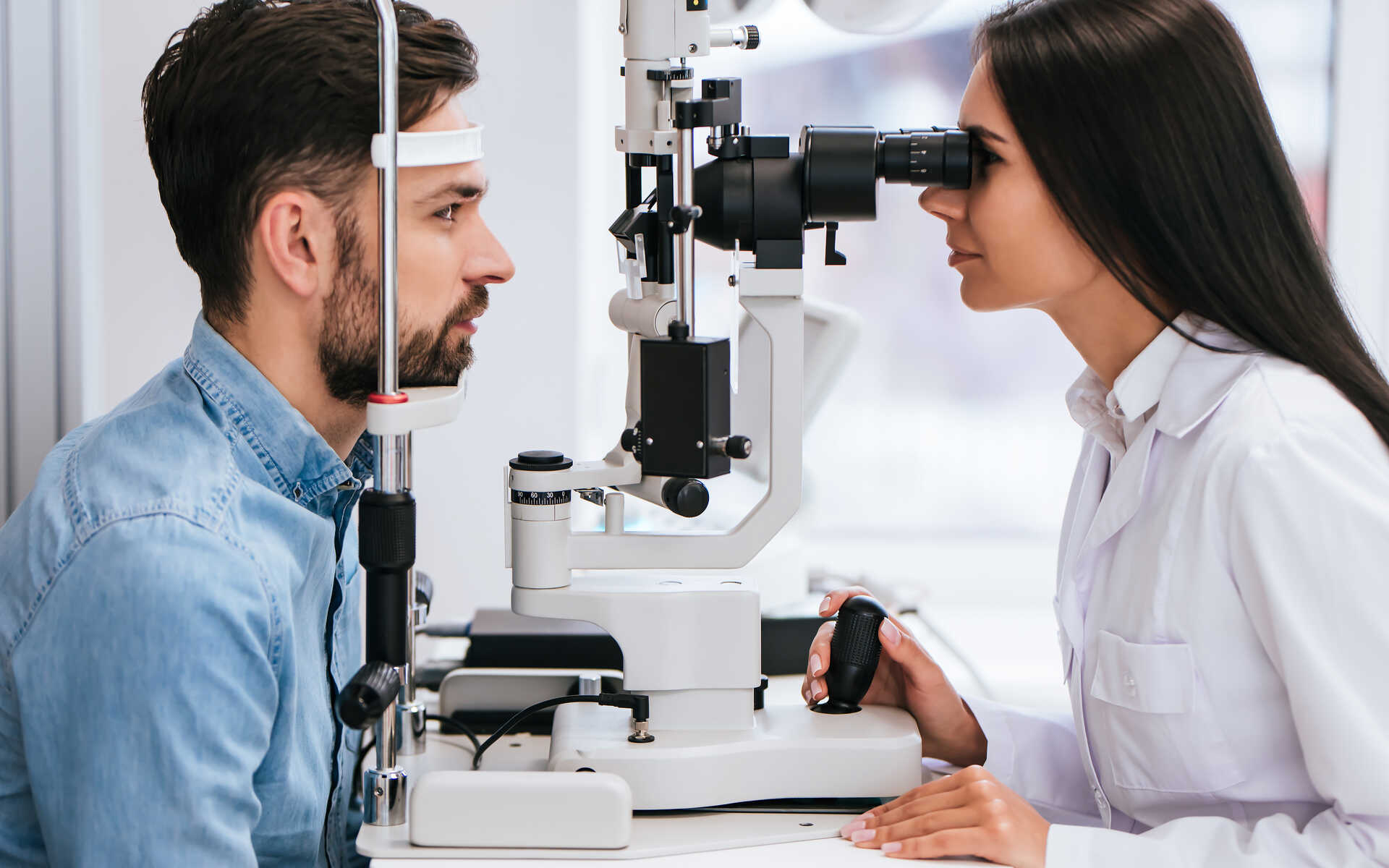 VCD save on eye care A man receives a comprehensive eye exam from an optometrist—an important step to save on eye care by detecting issues early.