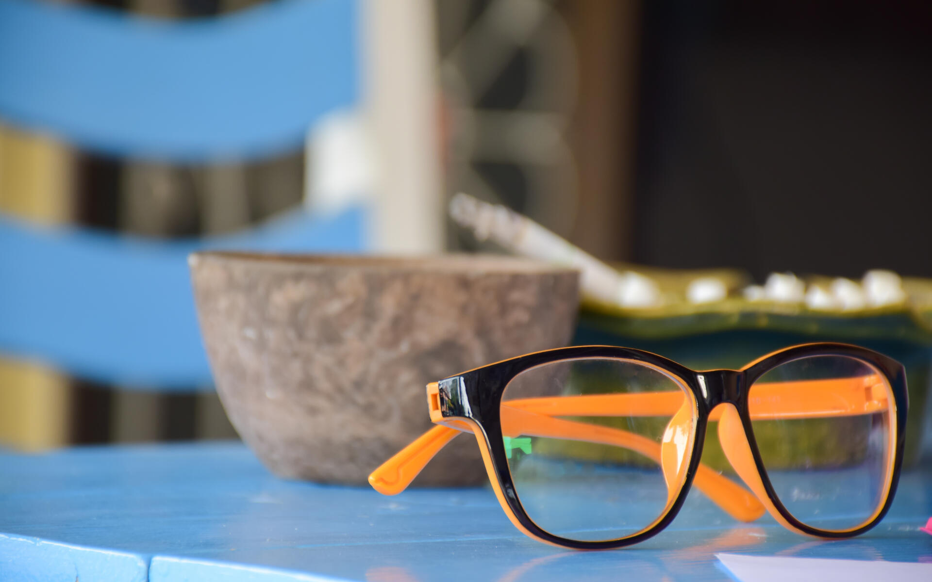 professional vision care Close-up of stylish eyeglasses on a blue table, symbolizing professional vision care.