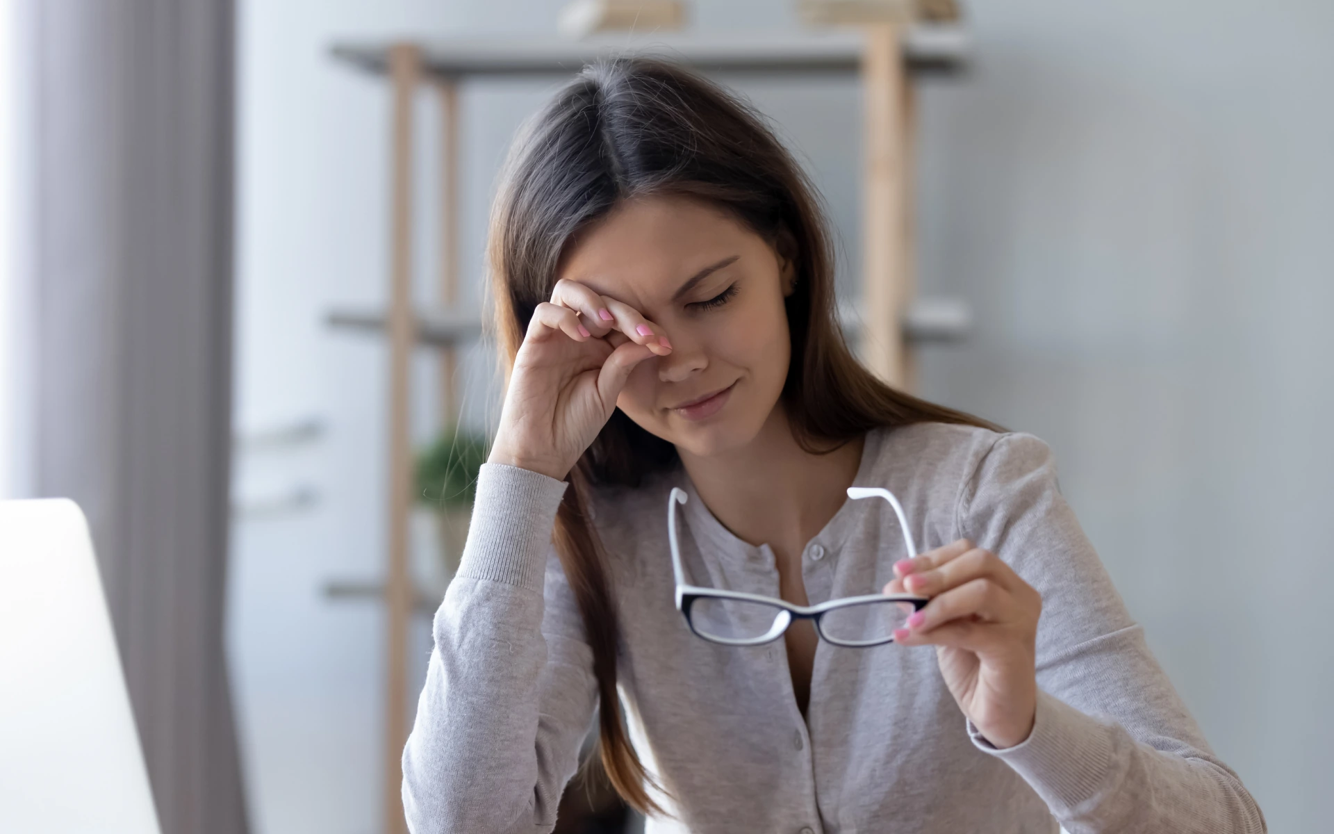 tired-worker-rubbing-irritable-eyes-feeling-fatigue-from-computer-work-concept-overworked-woman-taking-off-glasses-relieve-eye-strain-suffering-from-bad-eyesight-vision Woman rubbing her eyes and holding glasses, showing signs of strain related to workplace eye health.