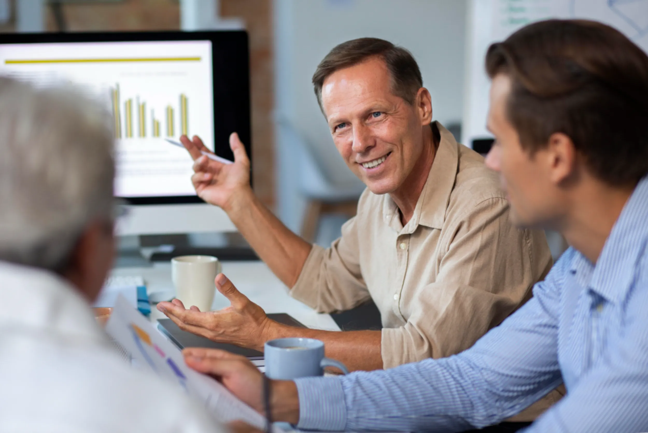 Business professionals discussing employee benefits strategy for 2026 during a meeting.